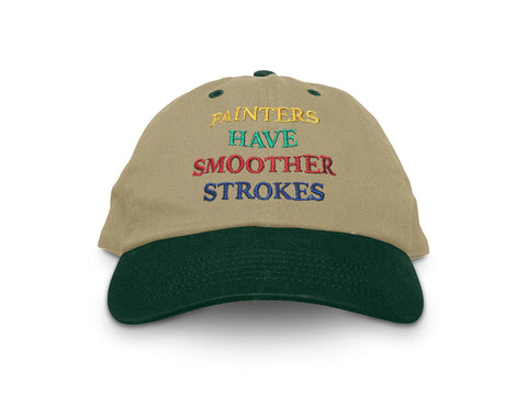 Image of front of khaki hat with green bill, with "Painters have smoother strokes" embroidered in yellow, green, red, and blue