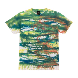 An image of a white t-shirt with dyed colorful stripes, with "COLOURED" written on the bottom and "COLOURED" embroidered in rainbow colors.