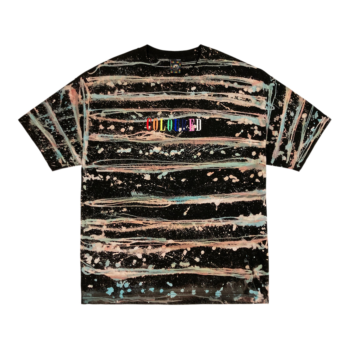 An image of a black t-shirt with bleached and dyed stripes and dots and "COLOURED" embroidered in rainbow colors.