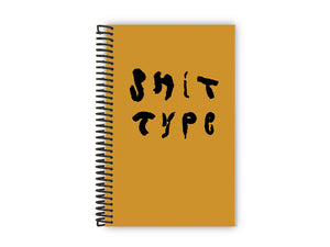 Image of a yellow ochre book with black coil binding on the left. "SHIT TYPE" is spelled on the cover in black.