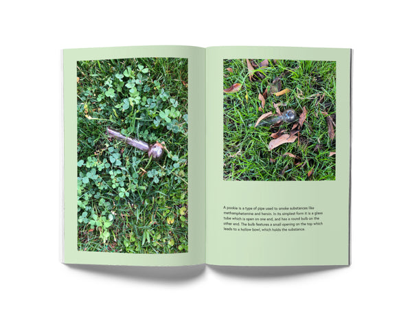 Image of an interior spread of the book "Street Snacks." On the left page is a photo of a used meth pipe laying on grass. On the facing page is a photo of another meth pipe on grass, and below the photo is a paragraph of text.