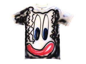 Photo of an airbrushed t-shirt with a smiley face by artist Devin Troy Strother.