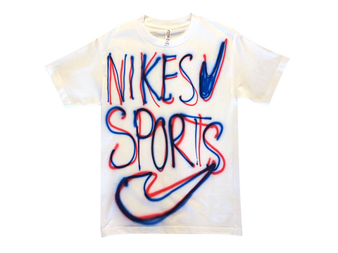 Photo of an airbrushed t-shirt with the words "Nikes Sports" and two swoosh logos by artist Devin Troy Strother.