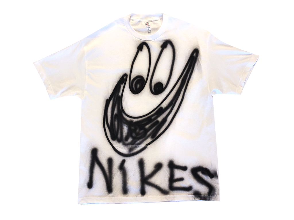 Photo of an airbrushed t-shirt with a smiley face with the word "Nikes" by artist Devin Troy Strother.